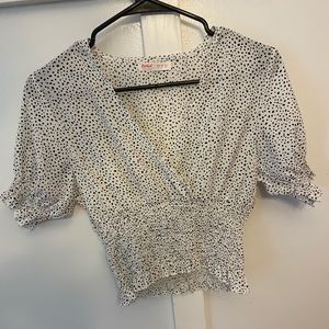 Black and white polka dot shirt.